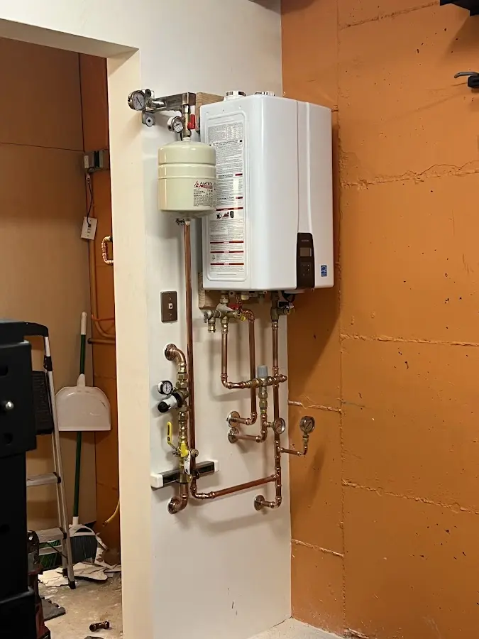 Plumbing technician inspecting water heater connections in Delaware